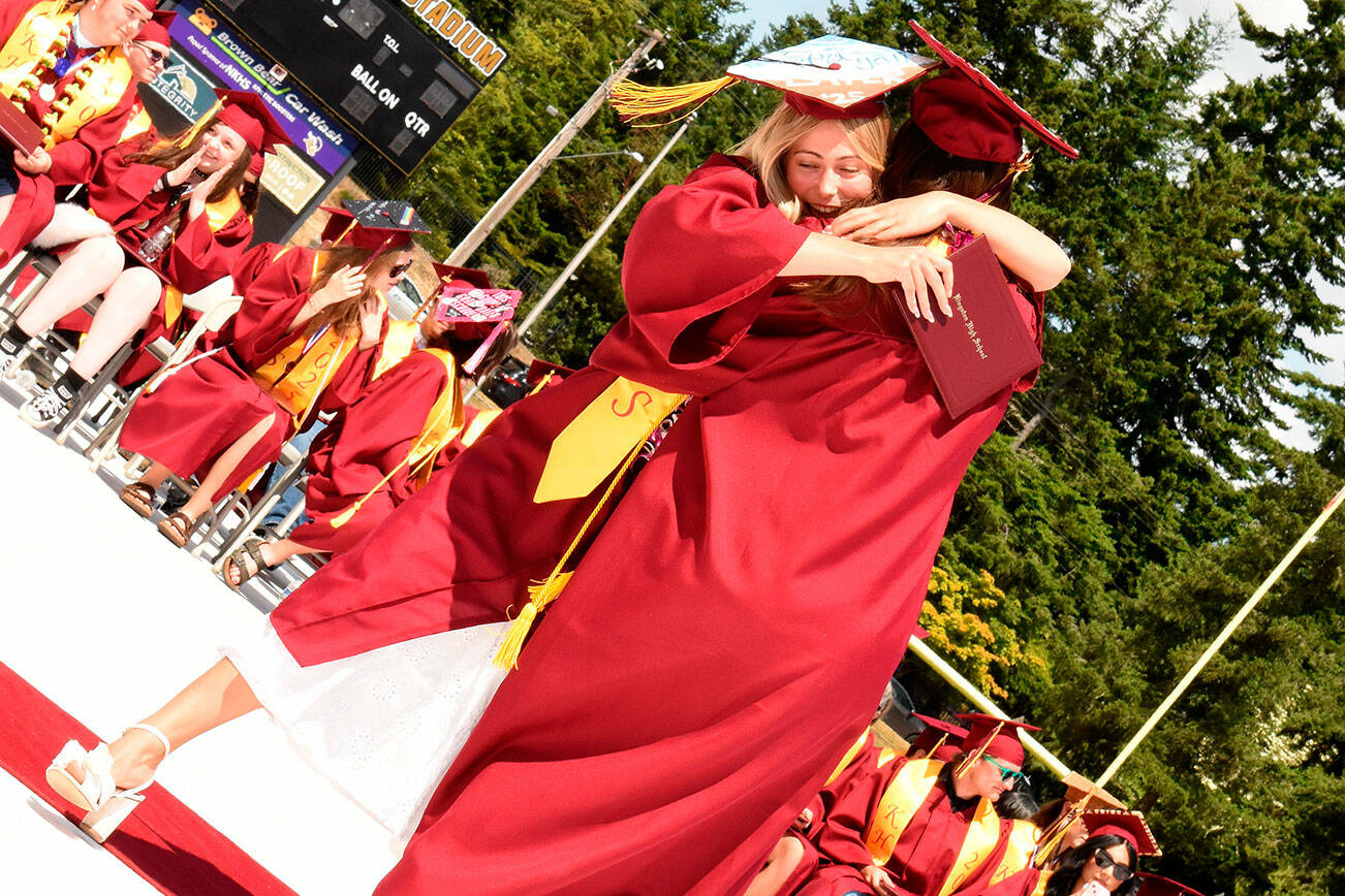 Katrina Daroff/Kitsap News Group photos
Two Kingston High School graduates hug in celebration after receiving their diplomas.
