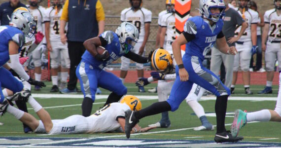 Luke Caputo/Kitsap News Group photos
Olympic running back Chace Webster stiff-arms an Aberdeen defender in a 27-25 Trojan loss to the Bobcats Sep. 5 at Integrity Roofing Stadium.