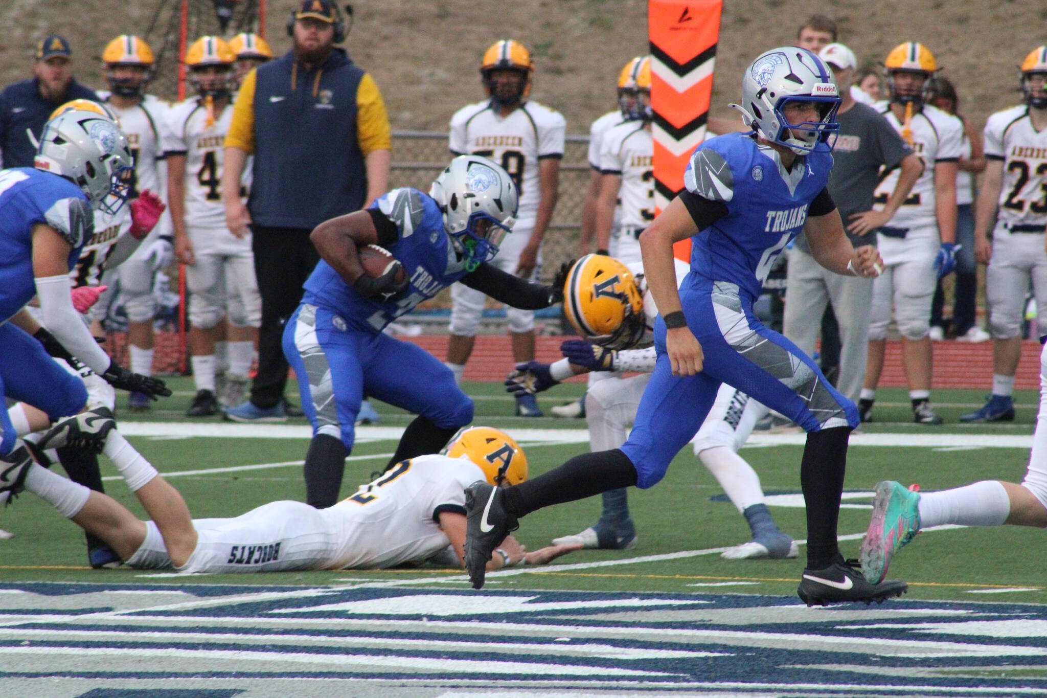 Luke Caputo/Kitsap News Group photos
Olympic running back Chace Webster stiff-arms an Aberdeen defender in a 27-25 Trojan loss to the Bobcats Sep. 5 at Integrity Roofing Stadium.