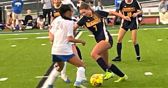 Luke Caputo/Kitsap News Group
Spartan Siri Smith pushes the ball past an incoming Olympic defender in a 7-0 Bainbridge home win Sept. 11.
