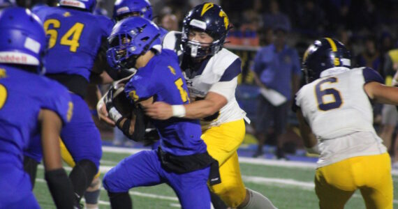 Luke Caputo/Kitsap News Group photos
Bainbridge Spartan Zack Ausmeier wraps up Knight Kenneth Najera in a 41-14 Bremerton home win Sept. 19.