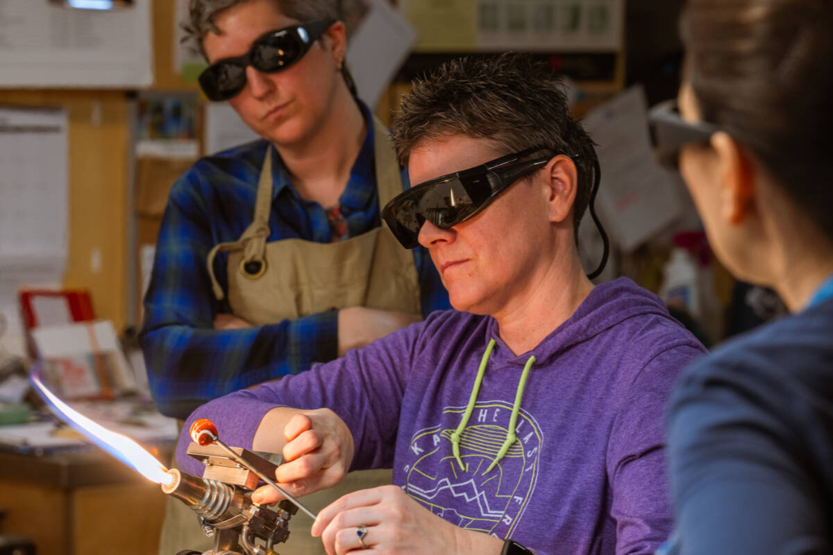BARN Glass Arts instructor Laura Arns demonstrates torchworking techniques during a workshop. Courtesy BARN