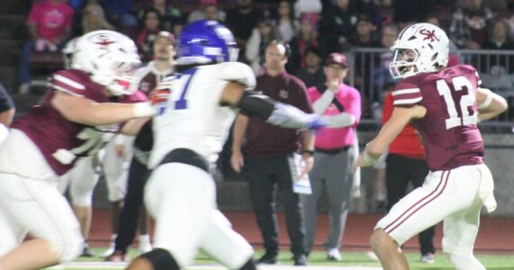 Luke Caputo/Kitsap News Group photos
SK quarterback Franklin Fox looks to evade an incoming Curtis defender in a 41-15 loss to the Vikings Oct. 3 at Kitsap Bank Stadium in Port Orchard.