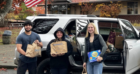 Chanel Fake courtesy photos
Josue May (left), Emilie May (center) and Lisa Johnson (right) pose outside of North Kitsap High School with their donations for the Port Gamble S’Klallam Tribe.