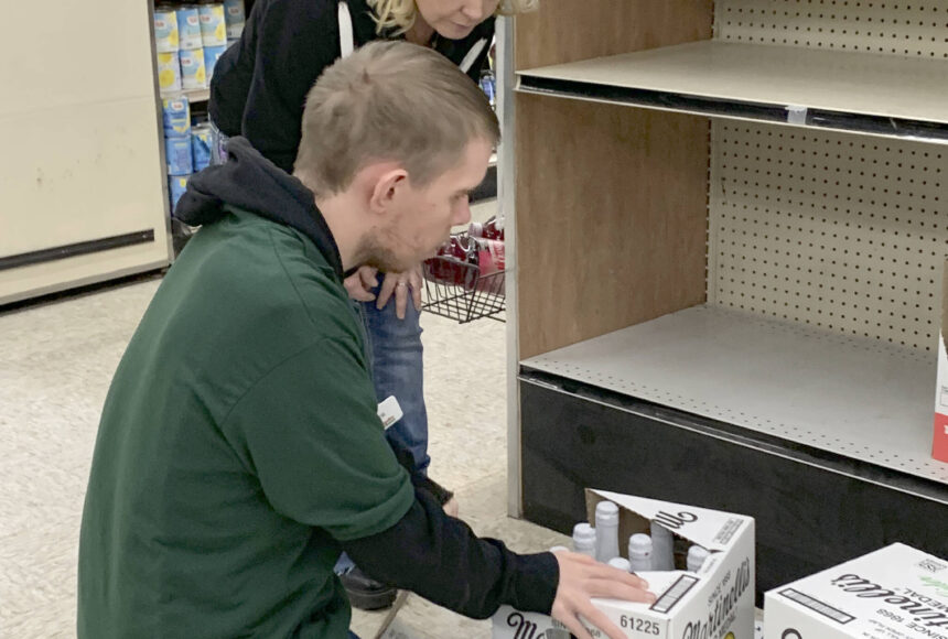 <p>Katrina Daroff/Kitsap News Group</p>
                                <p>North Kitsap High School Bridge Program student Zach Layton works to organize and stock a shelf with the help of his mother, Red Apple employee and Bridge Program volunteer Tasha Layton.</p>