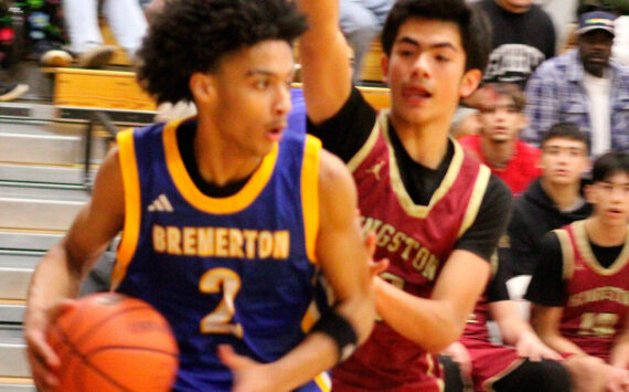Luke Caputo/Kitsap News Group photos
Knight Aaron Matthews keeps the ball away from Buccaneer Vaka Tameilau in a 94-50 Bremerton road win over Kingston Dec. 9.