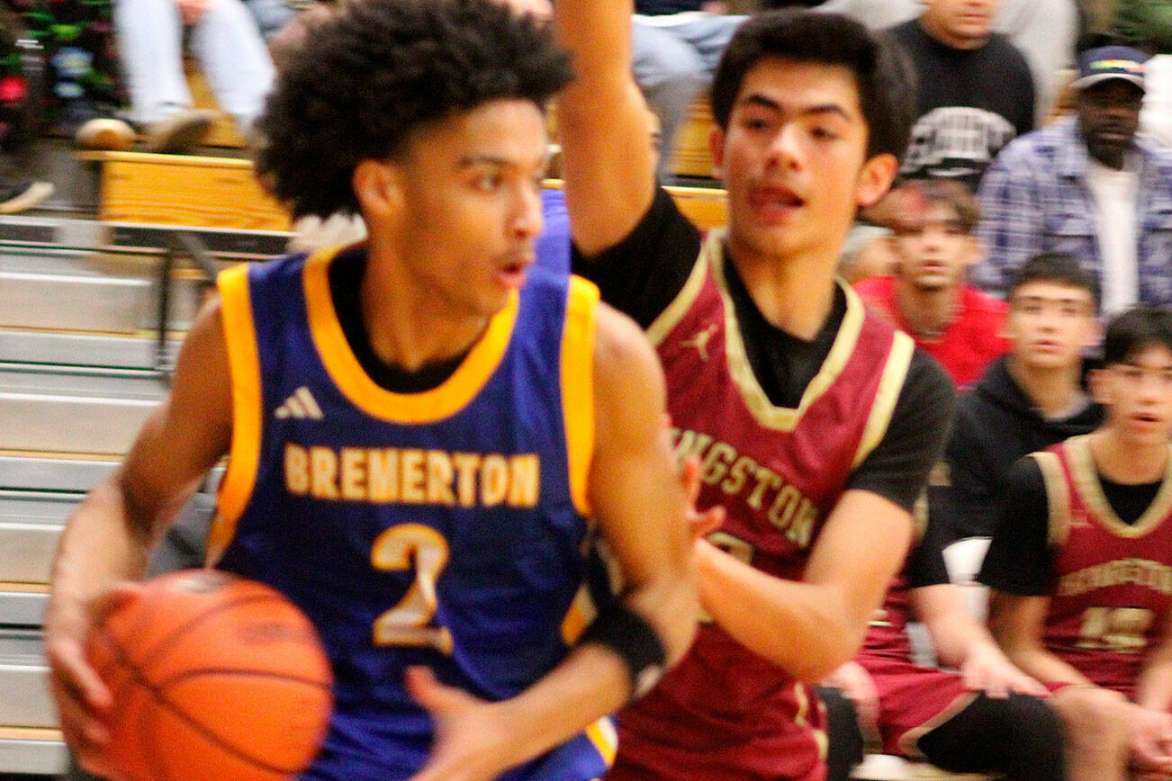 Luke Caputo/Kitsap News Group photos
Knight Aaron Matthews keeps the ball away from Buccaneer Vaka Tameilau in a 94-50 Bremerton road win over Kingston Dec. 9.
