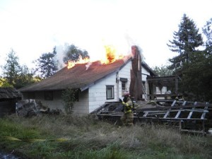 Flames shoot from a Silverdale house damaged by fire Tuesday night.