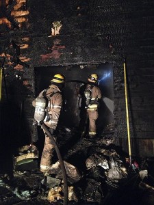 North Kitsap Fire & Rescue and Poulsbo Fire Department crews were called to the Sunridge Way house at 7:24 p.m. Jan. 18 after a neighbor called 911 when he stepped out onto his back porch to see the rear of the adjacent home ablaze. Flames were coming from the back doors