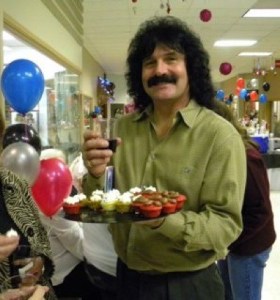 Port Orchard resident Jack Romo offers around a tray of mini-cupcakes at the Port Orchard Party on Saturday night.