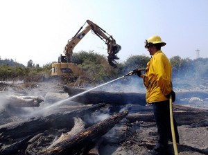 A bonfire is the suspected cause of this labor-intensive July 9 driftwood and brush fire at Point No Point Park. Outdoor fires