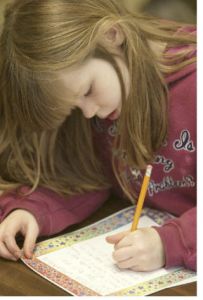 Jessica McMillen writes her letter to Alfred Williams explaining a book she read. Students in Chuck Vaughn’s and Suzy Gezell’s second grade class wrote letters Monday to a 70-year-old Missouri man who only recently learned to read.