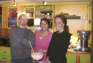Juice Bar owner Josh Zetzche (left) presents a perfect strawberry banana smoothie along with apprentice juicers Amy Durgan and Nicole Pavlik.