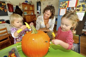 Kingston Cooperative Preschool teacher Debbie Manos works with “Owls” kids Ameena Deller