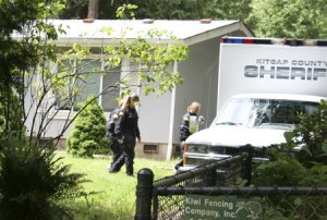 Kitsap County Sheriff’s Office investigators probe the scene of a shooting and stabbing in Olalla on Friday morning.