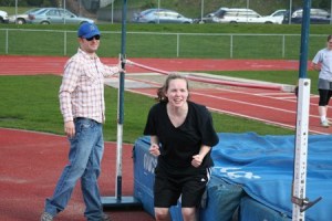 Bremerton High School track and field coach Jeremy Blum (left) leads high jump practice with Hannah Sersha Monday.