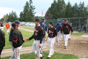 The Central Kitsap High School baseball team greets the Olympia High School squad after losing 12-3 at home Monday.