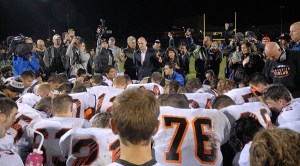 Dozens of Centralia High School football players surround Bremerton High School assistant football coach Joe Kennedy for a prayer on the 50-yard-line Oct. 16.