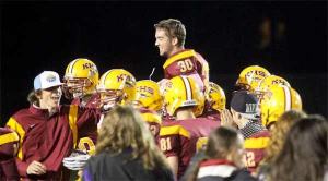 Kingston's Colin Stone is hoisted onto the shoulders of his teammates after kicking a 42-yard field goal to win the playoff game 40-37 against the Washington Patriots Nov. 2 at North Kitsap Stadium.