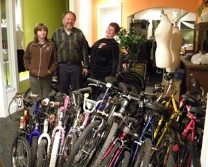The forty bikes were sent from Port Orchard to Ghana last week were prepared by Olympic Bike Shop owner Fred Karakas (center) for Point Hope Foundation director Jan Haynes (right). Anna Karakas (left) helped her father repair the bikes.