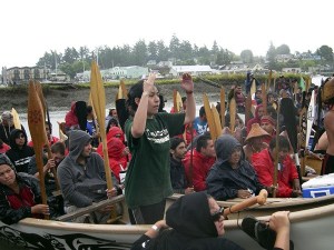 Erica Cardiel of Suquamish asks permission for her canoe pullers to come ashore