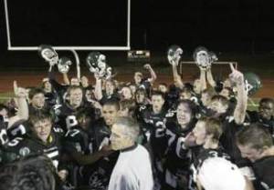 The Klahowya Eagles celebrate on the field at Silverdale Stadium following a 34-20 win against interdistrict rivals Olympic.