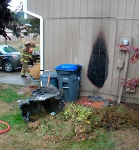 Central Kitsap Fire & Rescue firefighters driving by a home on Sheffield Court in East Bremerton Tuesday happened to notice flames coming from a garbage can and the side of the house and quickly extinguished the flames.
