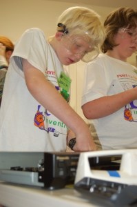 Justin Howard and Alexa Farley work on taking parts out of old household appliances during Sylvan Way Christian School's Camp Invention week.