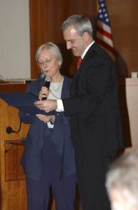 Kitsap County Commissioner Josh Brown receives a certificate from commissioner Charlotte Garrido denoting his service to the community. Brown's last day as a commissioner is Dec. 31.