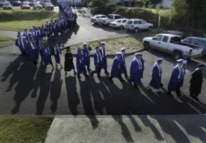 Olympic High School seniors make their way into the Kitsap Fairgrounds' Pavilion for graduation Saturday.