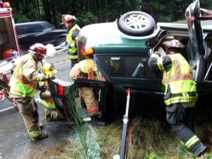 Firefighters remove a 51-year-old woman from her Subaru SUV on Bond Road near Rova Road