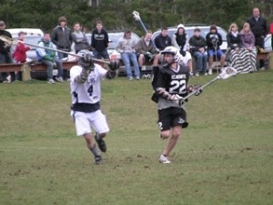 Klahowya's Chris McGuire moves up the field during the Eagles' 9-6 loss against Tacoma Thursday. McGuire scored one goal in the loss.