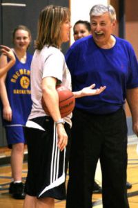 (Above) First-year BHS girls basketball coach Al Valencia shares a laugh with assistant Debbie Lindgren during practice Monday. (Below) Valencia offers instruction during a fast-break drill. (Right) Lindgren jokes with a group of players.