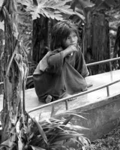 A reflective-looking Yanomani girl