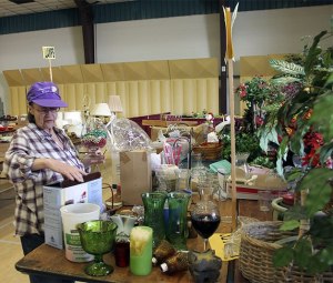 Vicki Bess sorts through craft items getting ready for the RAGS sale which is Saturday.