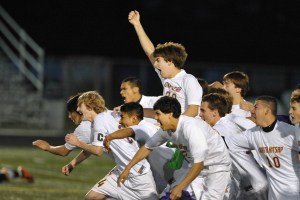 Members of the North Kitsap High boys soccer team celebrate Monday after their home victory over North Thurston in a sub-district playoff match. The Vikings won