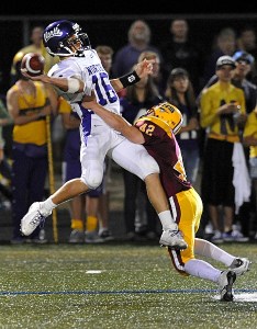 Kingston High School player Michael Johnson attempts to get the sack on North Kitsap's Alex Nettleton during the rivalry game at North Kitsap Stadium Friday.