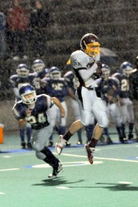 South Kitsap receiver Ricky Johnson hauls in a pass in a driving rain on Saturday night against Stadium.
