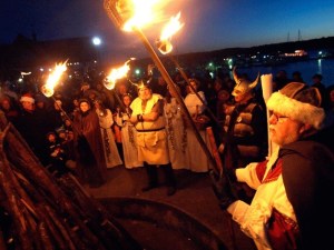 Vikings wait for the Lucia Bride to light the bonfire.
