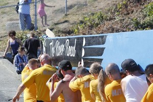 Sailors from Naval Base Kitsap carry a canoe ashore during the July 25 landings at Suquamish.