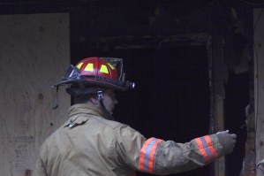 Bremerton Fire Marshal Mike Six prepares to enter Unit 112B at the Madrona Estates apartment complex to investigate a Christmas Eve fire. The blaze claimed the life of Dora M. Crockett