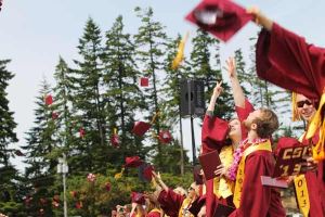 The 2013 graduates of Kingston High School toss their caps into the air to conclude the graduation ceremony June 15 at North Kitsap Stadium.