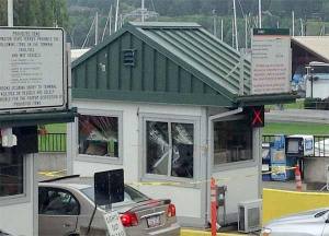 A driver of a tractor-trailer was cited for an oversized load by the Washington State Patrol after logs from the trailer struck a toll booth at the Kingston ferry landing