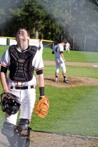 Cougar’s catcher walks back to home after a time out.