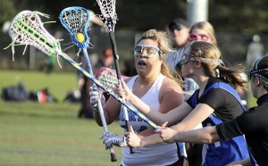North Kitsap’s Victoria Vanderhaden looks for an opening during a challenge by Curtis defenders March 24 at Strawberry Field. Vanderhaden had three goals and two ground balls in North Kitsap’s 12-11 win.