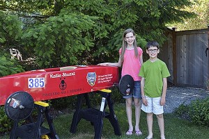 Katie and Quinny Stuart stand in front of Katie’s stock car.