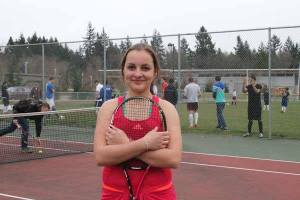 Kati Schwabe stops for a photo Wednesday during tennis practice at the Kingston High School tennis courts. Schwabe