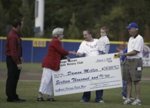 Silverdale Rotarian Patricia Roberts shakes hands with Damon Miller