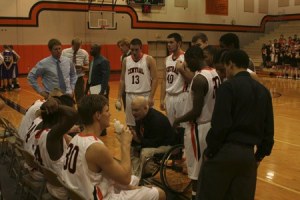Central Kitsap High boys basketball coach Scott McMinds speaks with his team Tuesday during a loss to Puyallup High.