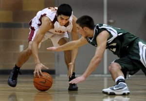 Kingston High guard George Hill snatches a loose ball away from Port Angeles' Colin Wheeler Tuesday at the Kingston High gym.